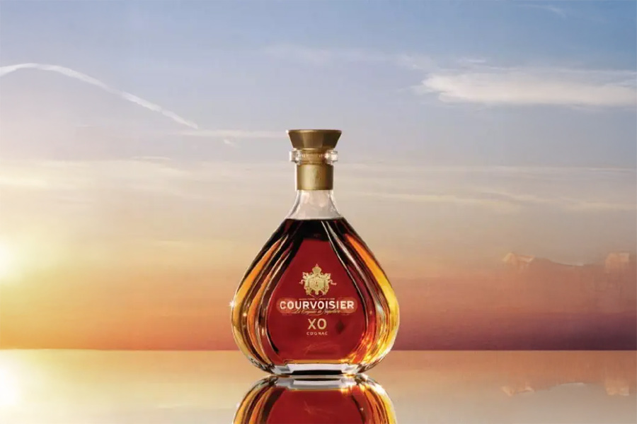 Courvoisier XO cognac bottle at sunset